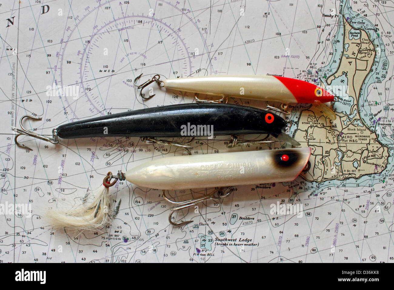 Fishing lures lie on a nautical chart. Stock Photo