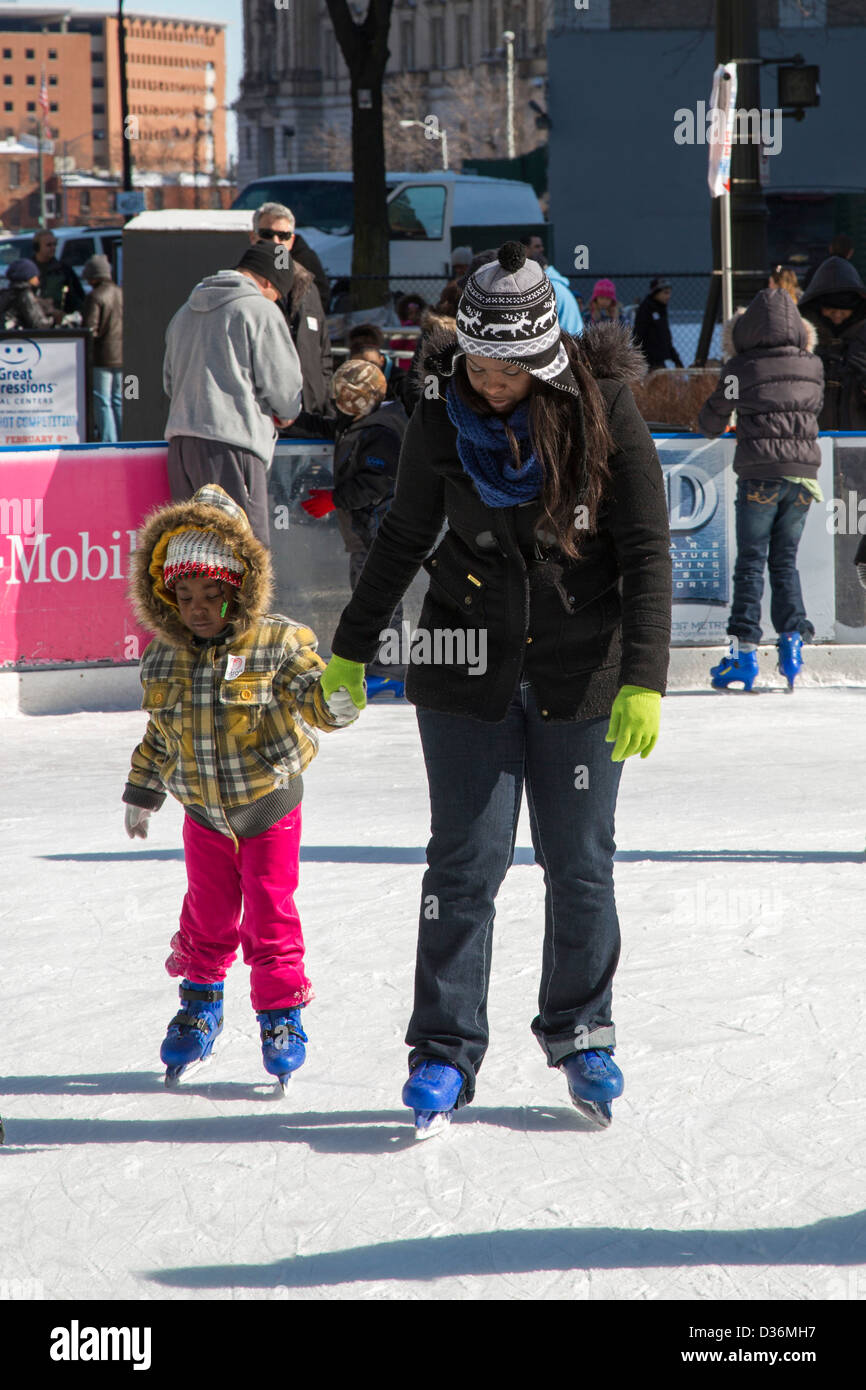 People skate on the ice rink in Campus Martius Park during Detroit's Winter Blast festival. Stock Photo