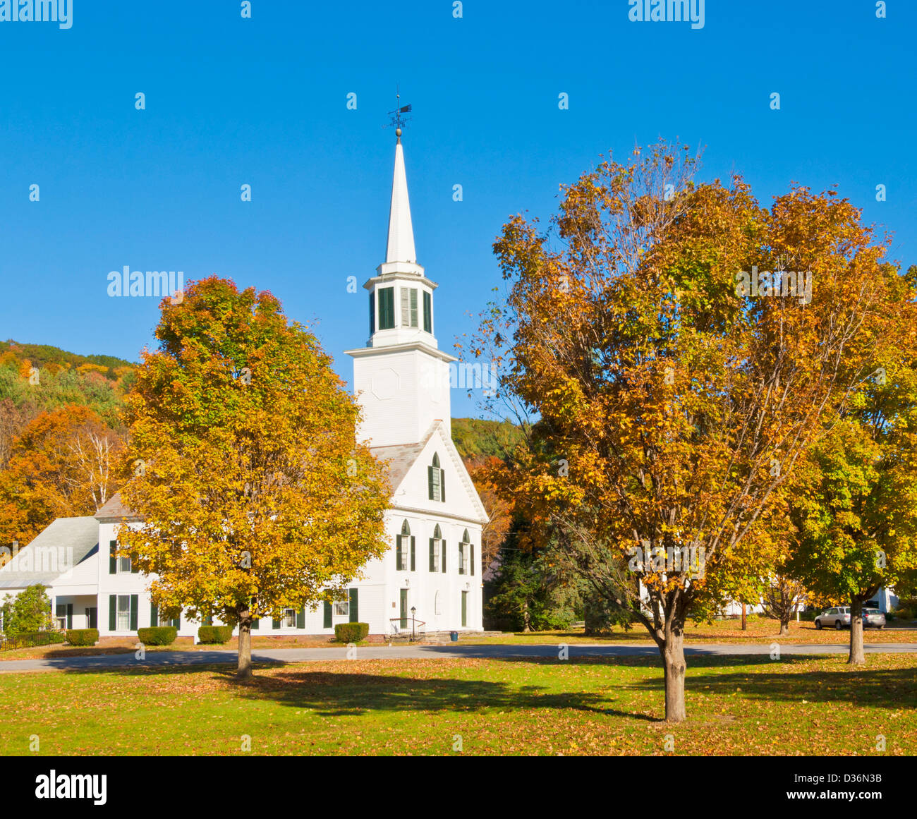 Autumn colours around the traditional white timber clad church Townshend Vermont United States of America USA Stock Photo