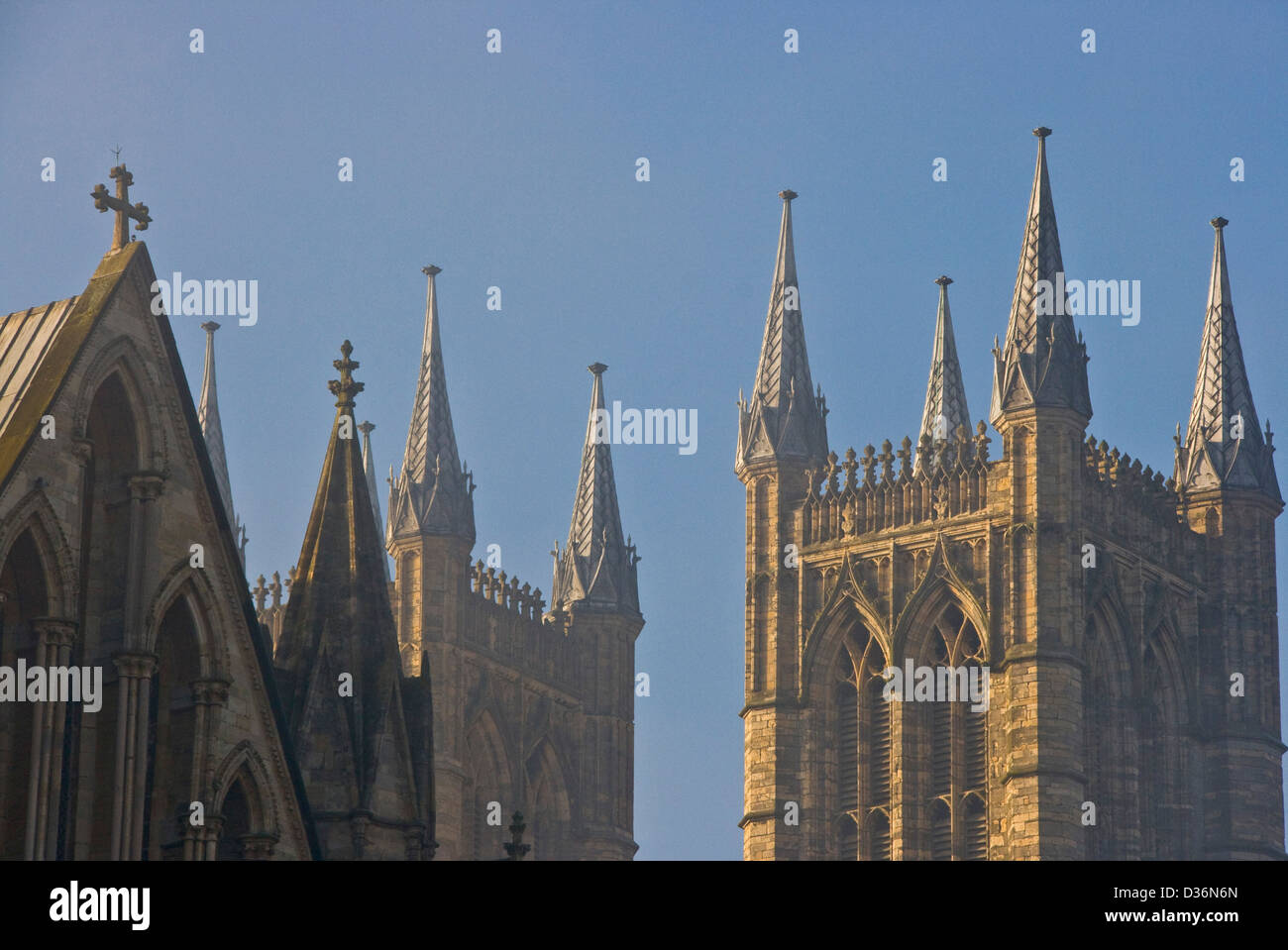 Gothic towers of grade 1 listed Lincoln Cathedral in morning fog mist Lincolnshire England Europe Stock Photo