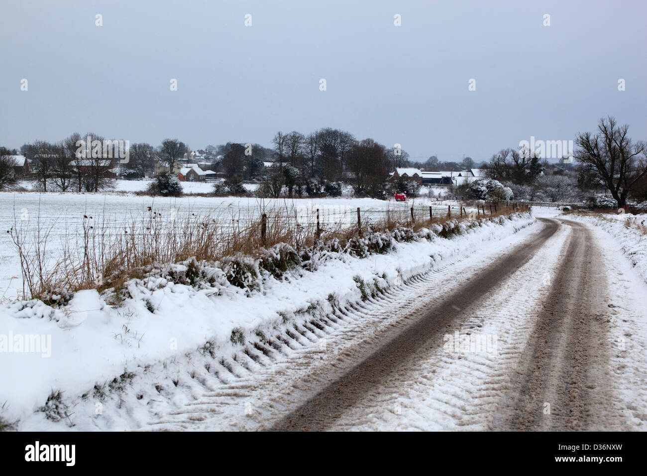 Road leading to the village of Stanton St Bernard in the snow Stock Photo