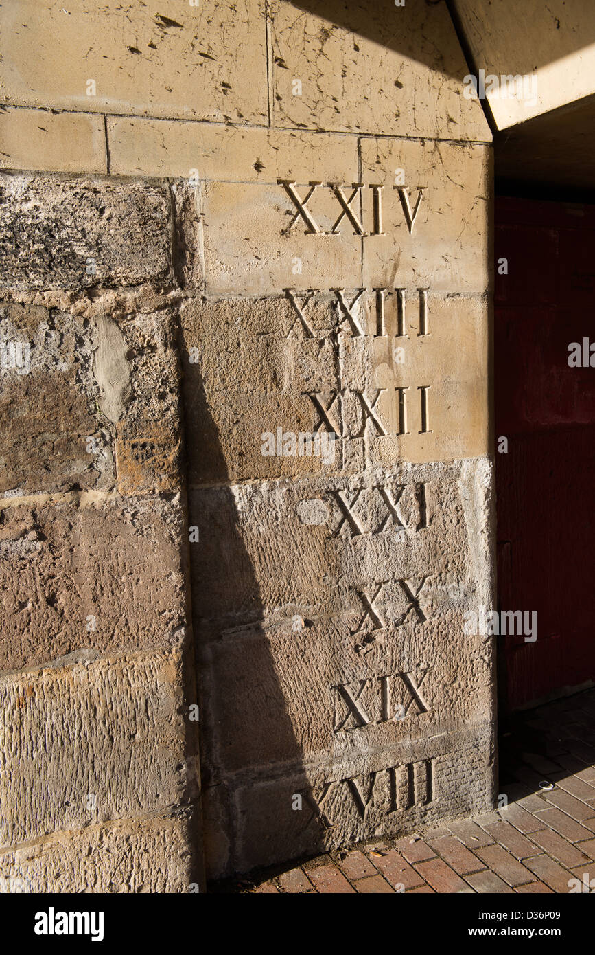 Roman numerals carved on stone wall Stock Photo