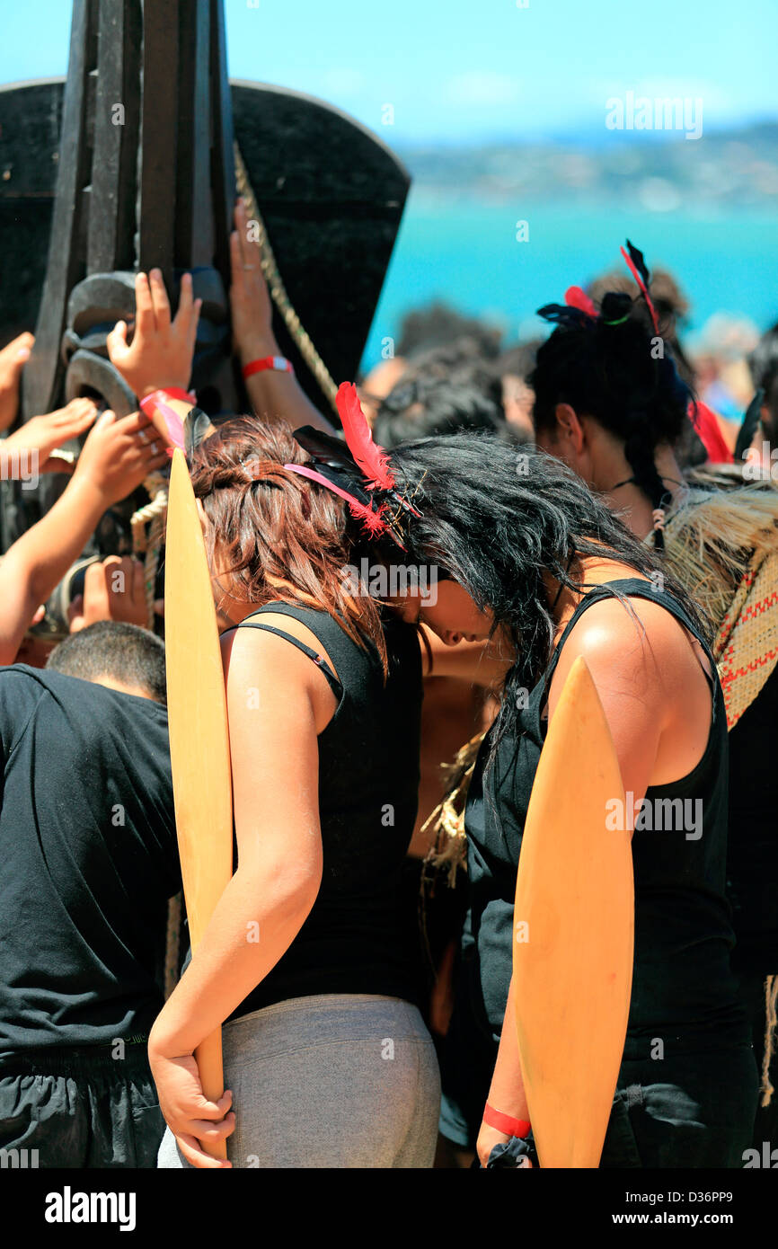 Maori waka crew hold onto the great waka Ngatokimatawhaorua at the Waitangi Treaty Grounds during Waitangi Day celebrations. Stock Photo