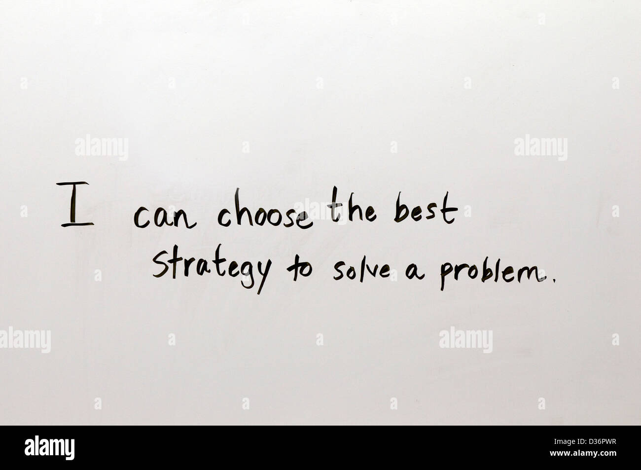 Lesson for school or work application written by hand in good penmanship on a white board: I can choose the best strategy to solve a problem. Stock Photo