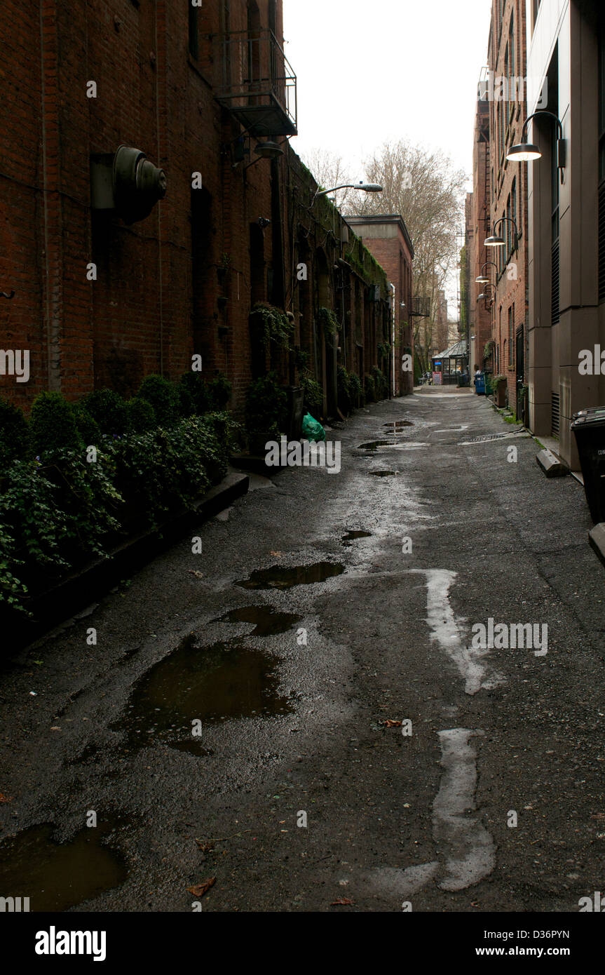 Puddles in city alley Stock Photo
