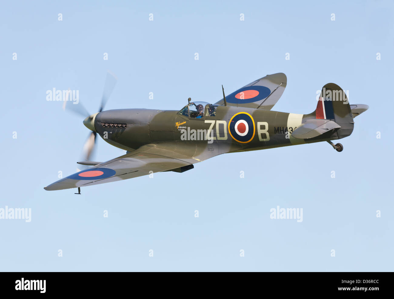 Spitfire mk9 owned by the old flying machine company based at Duxford performs a flypast. Stock Photo