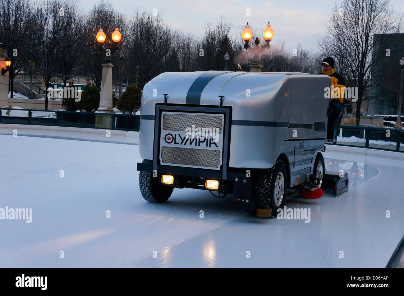 Machine to melt smooth ice for skaters. An ice resurfacer smoothing ice rink Stock Photo