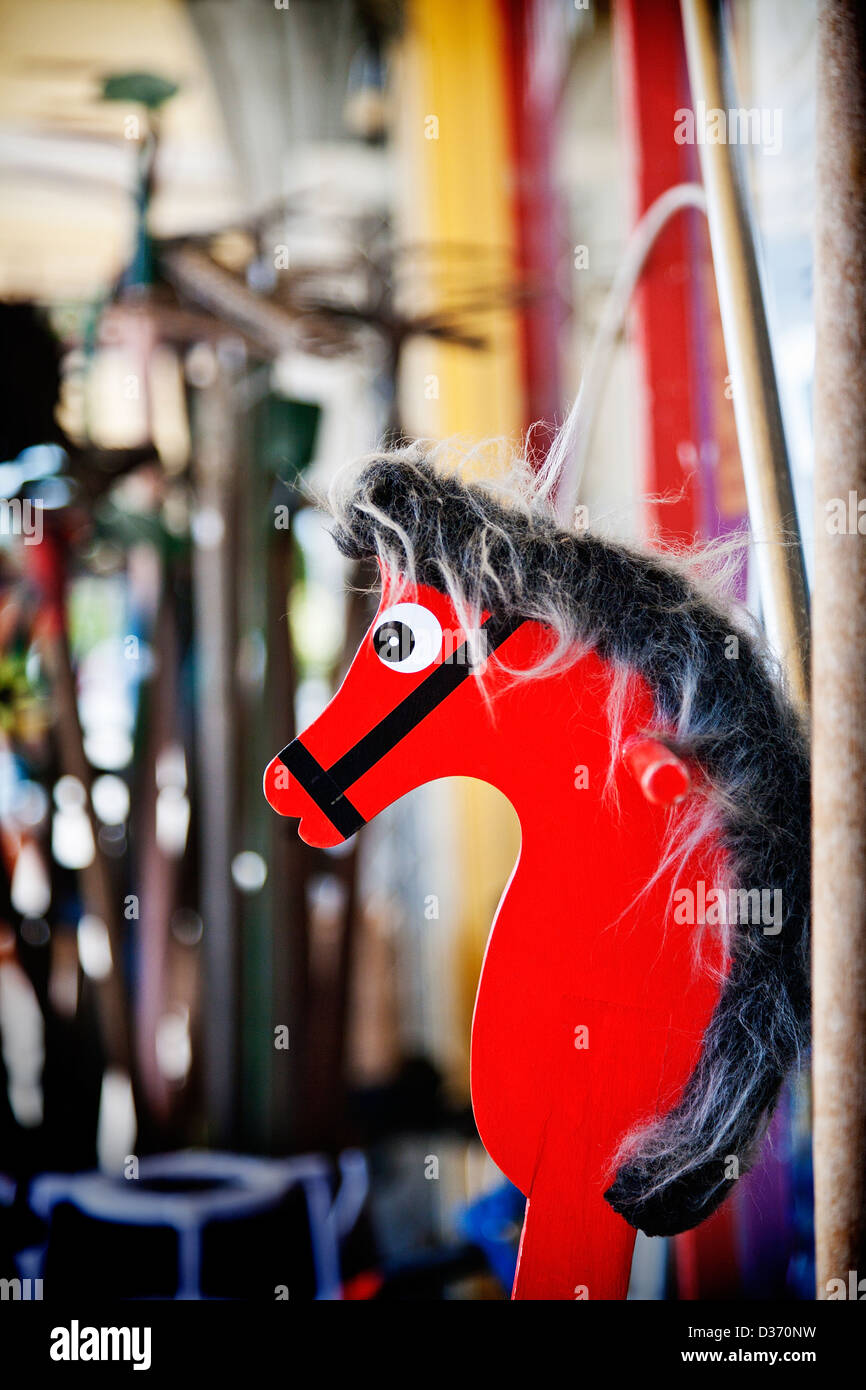 An old bright red wooden vintage hobby horse for sale outside an old junk shop. Canterbury, South Island, New Zealand. Stock Photo