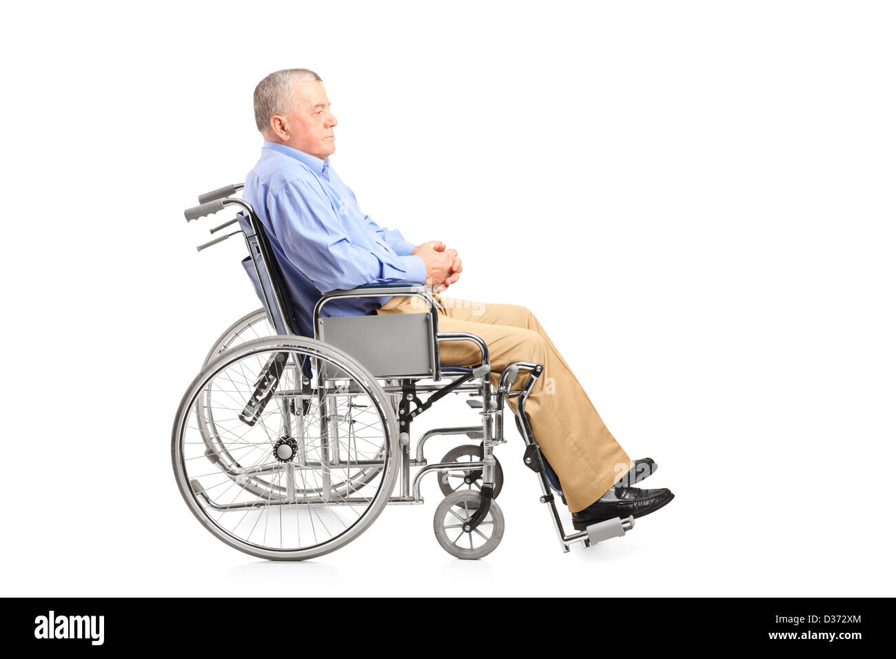 A disabled senior man posing in a wheelchair isolated on white ...