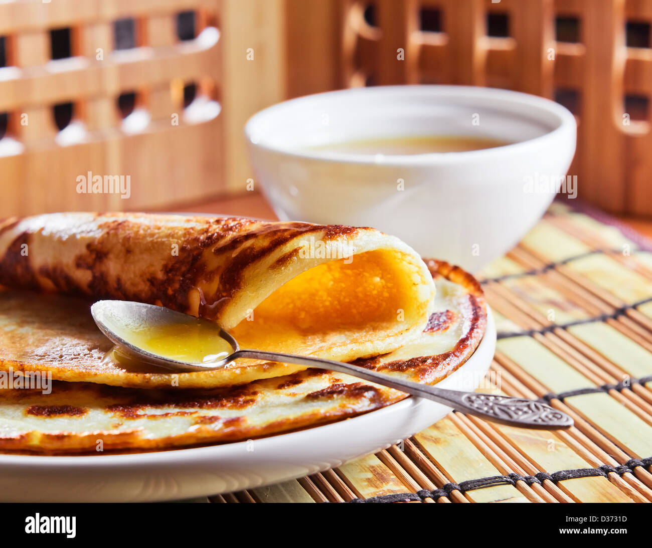 thin pancake and some sweet honey Stock Photo Alamy