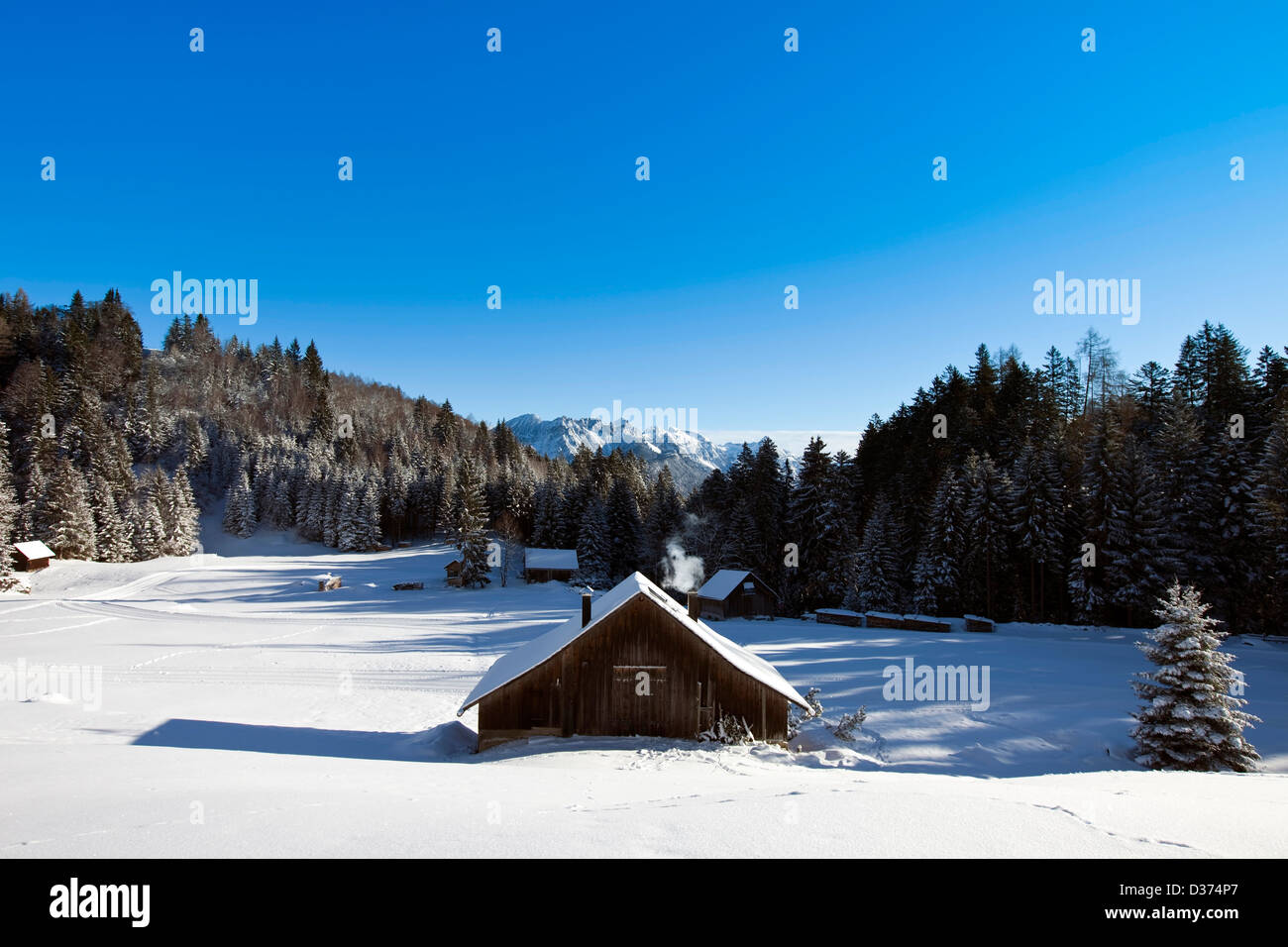 Rural Sunny Winter Landscape With Occupied Log Cabins In The Stock