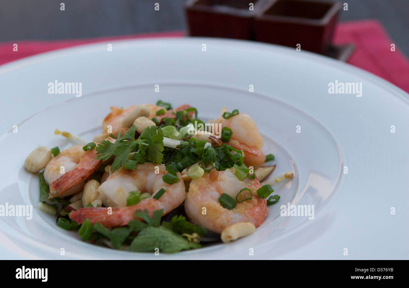 Prawn salad with mint, basil and crunchy peanuts served in a white bowl Stock Photo