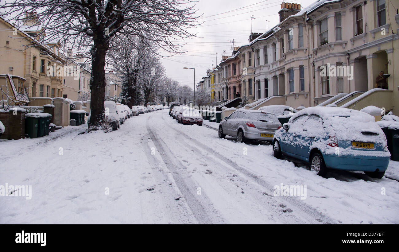 Cars parked in terraced street in snow, Brighton,UK Stock Photo