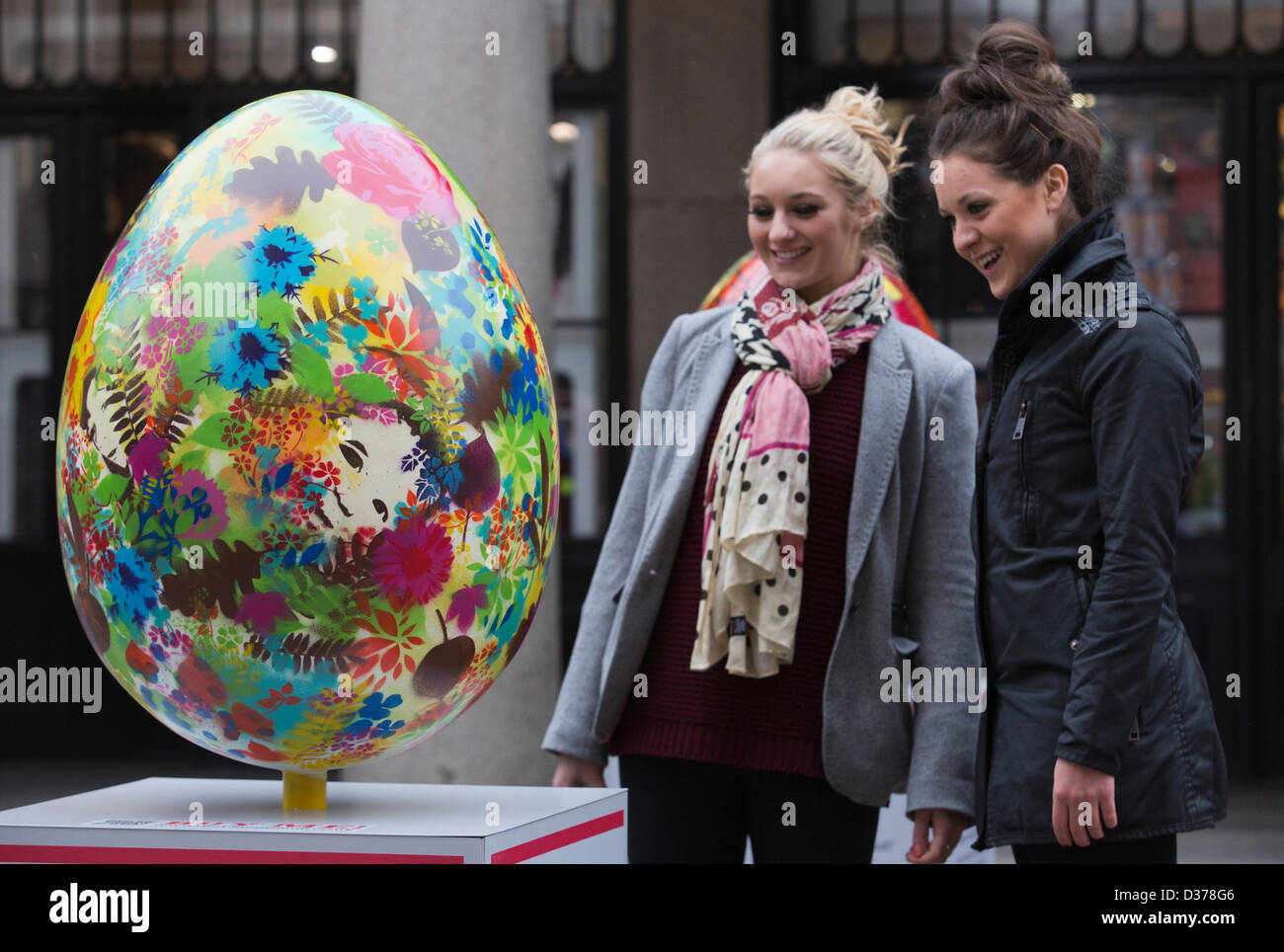 London, UK. 12th February 2013.  Veronica Fulton, 21, and Imogen Money, 22, from London admire the eggs. Over 100 giant Easter eggs designed by artists and designers were unveiled today in Covent Garden Piazza, London, to launch The Lindt Big Egg Hunt in support for the charity 'Action for Children'. For six weeks, from 12 February to 1 April 2013, giant Easter eggs will tour the country, from London's Covent Garden to Birmingham, Liverpool, Manchester, Glasgow and back to London in time for Easter. Photo: Nick Savage/Alamy Live News Stock Photo