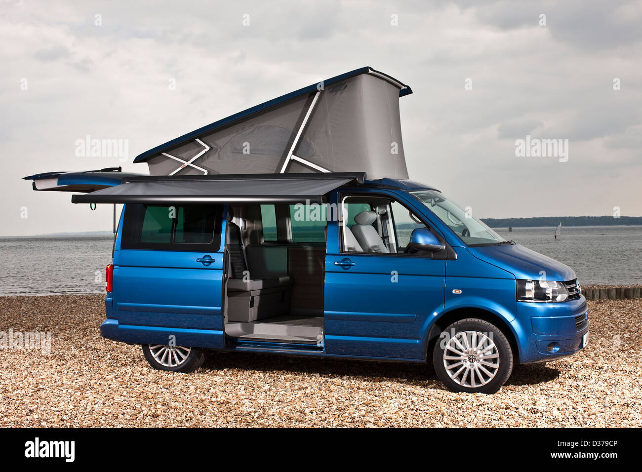 Blue metallic VW California campervan with optional awning on Southampton beach, UK, 07 05 2010 Stock Photo