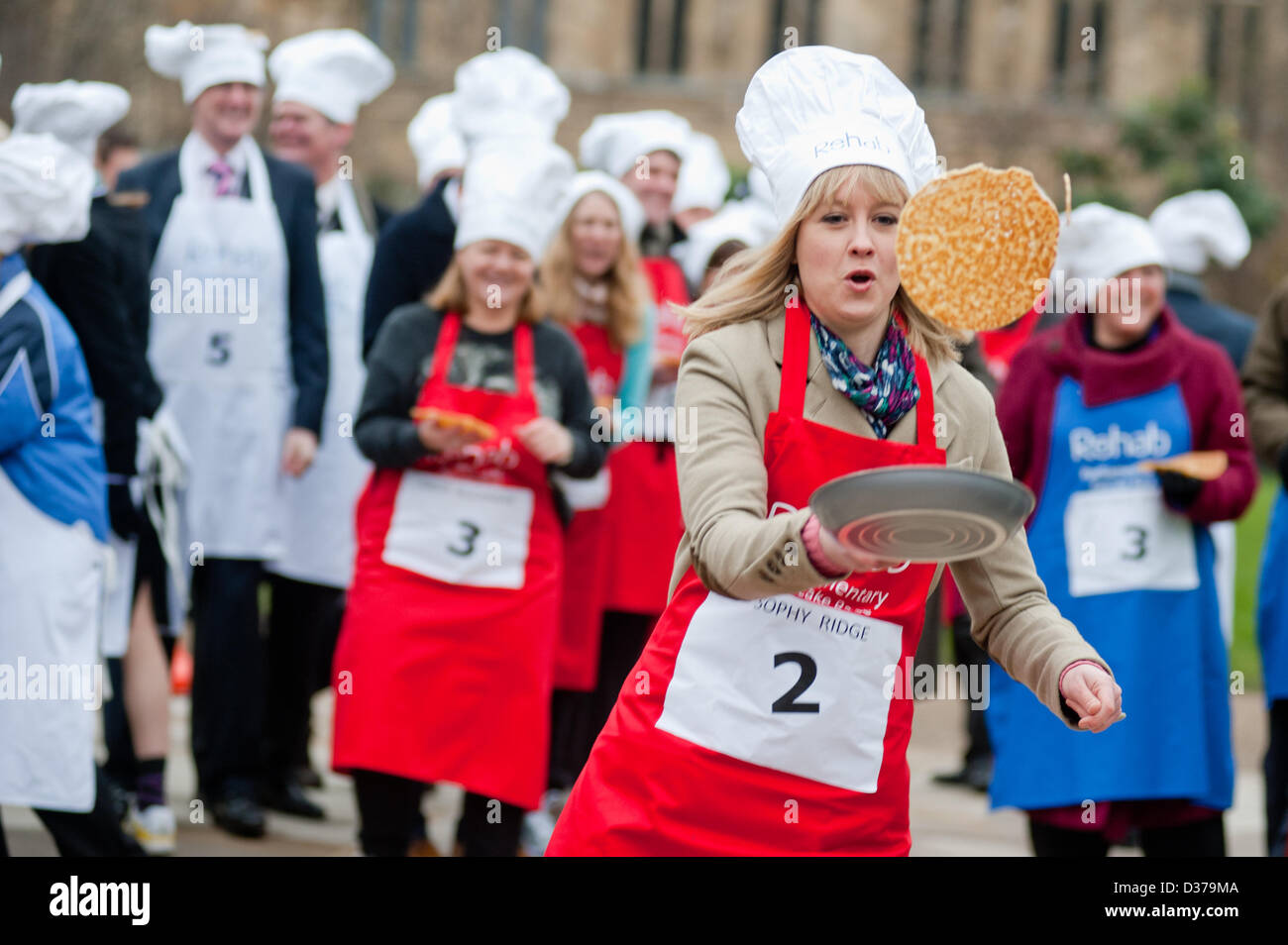 London, UK. 12th February 2013. – the 16th Parliamentary Pancake Race takes place next to the Houses of Parliament on Shrove Tuesday raising money for the charity Rehab. Politicians and MPs toss pancakes into the air and catch them in the pan whilst running.The team of MPs has won the event this year. pcruciatti / Alamy Live News Stock Photo