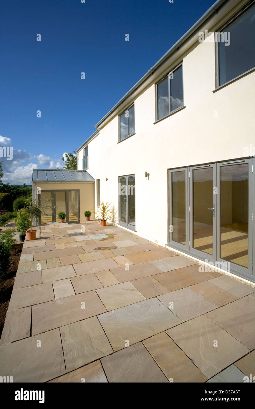 UK real estate. A new build house with a large stone flag patio terrace