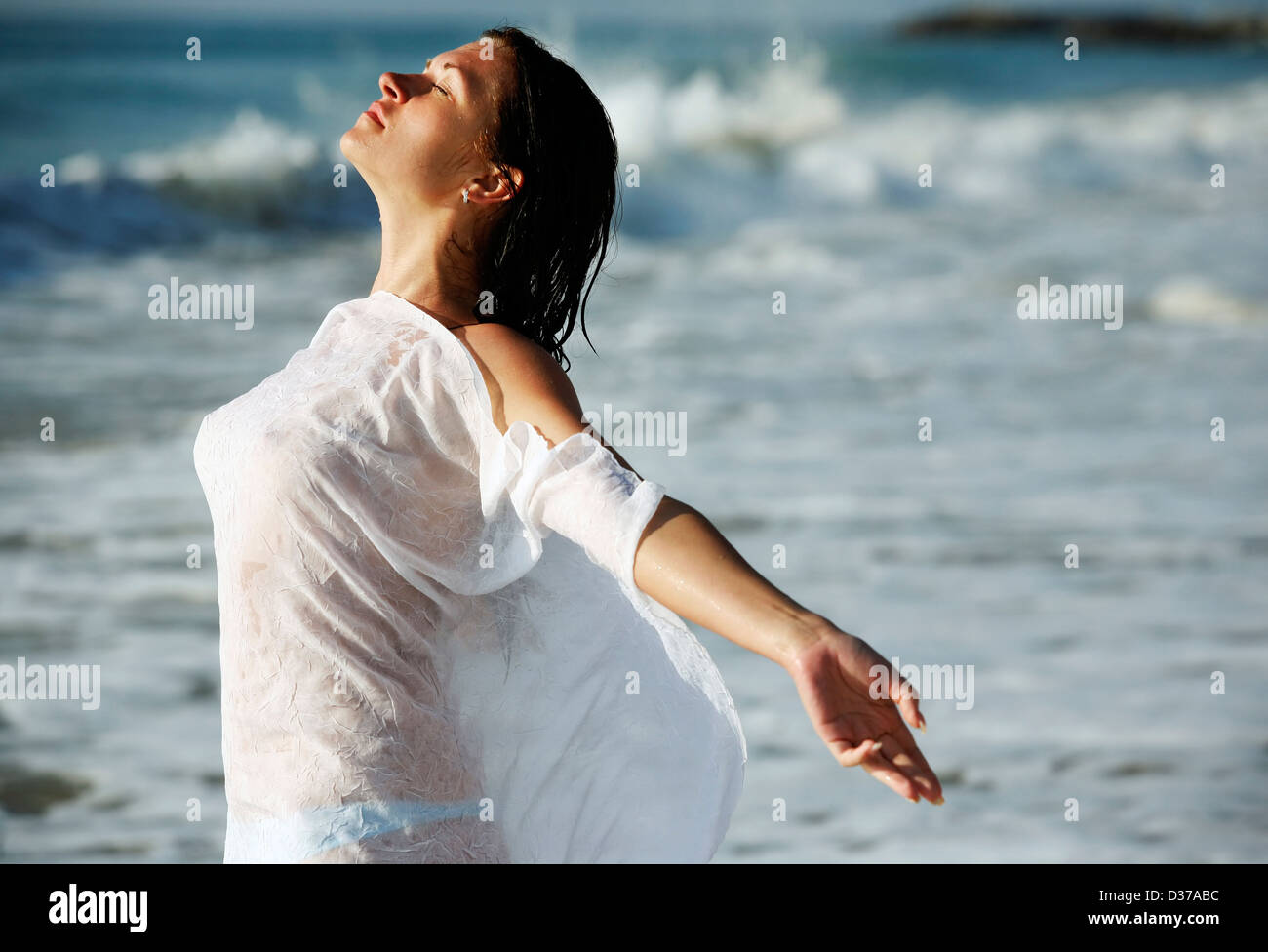 The pretty woman in a wet vest on a beach Stock Photo - Alamy