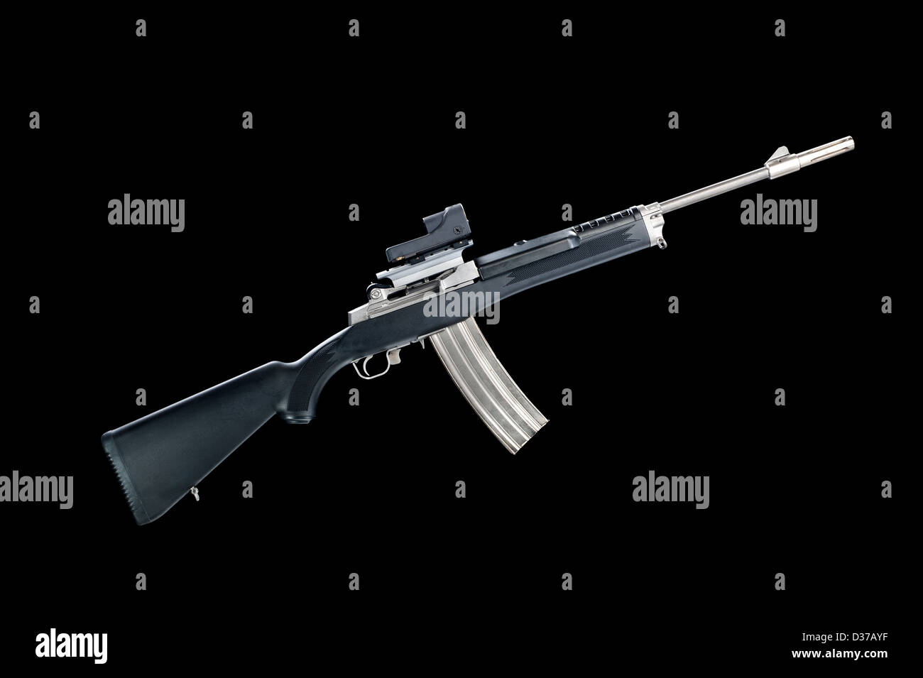 An assault rifle with a 30-round magazine isolated on a black background. Stock Photo