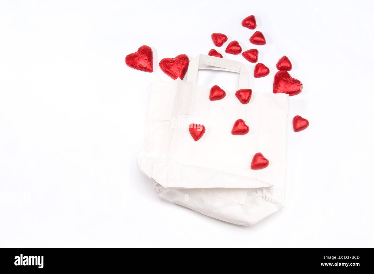 Red hearts scattered over a white paper Stock Photo