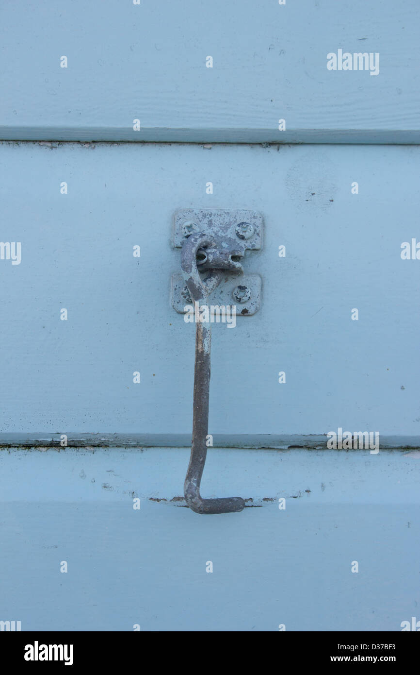 Close up of door / window hook against blue wooden wall Stock Photo