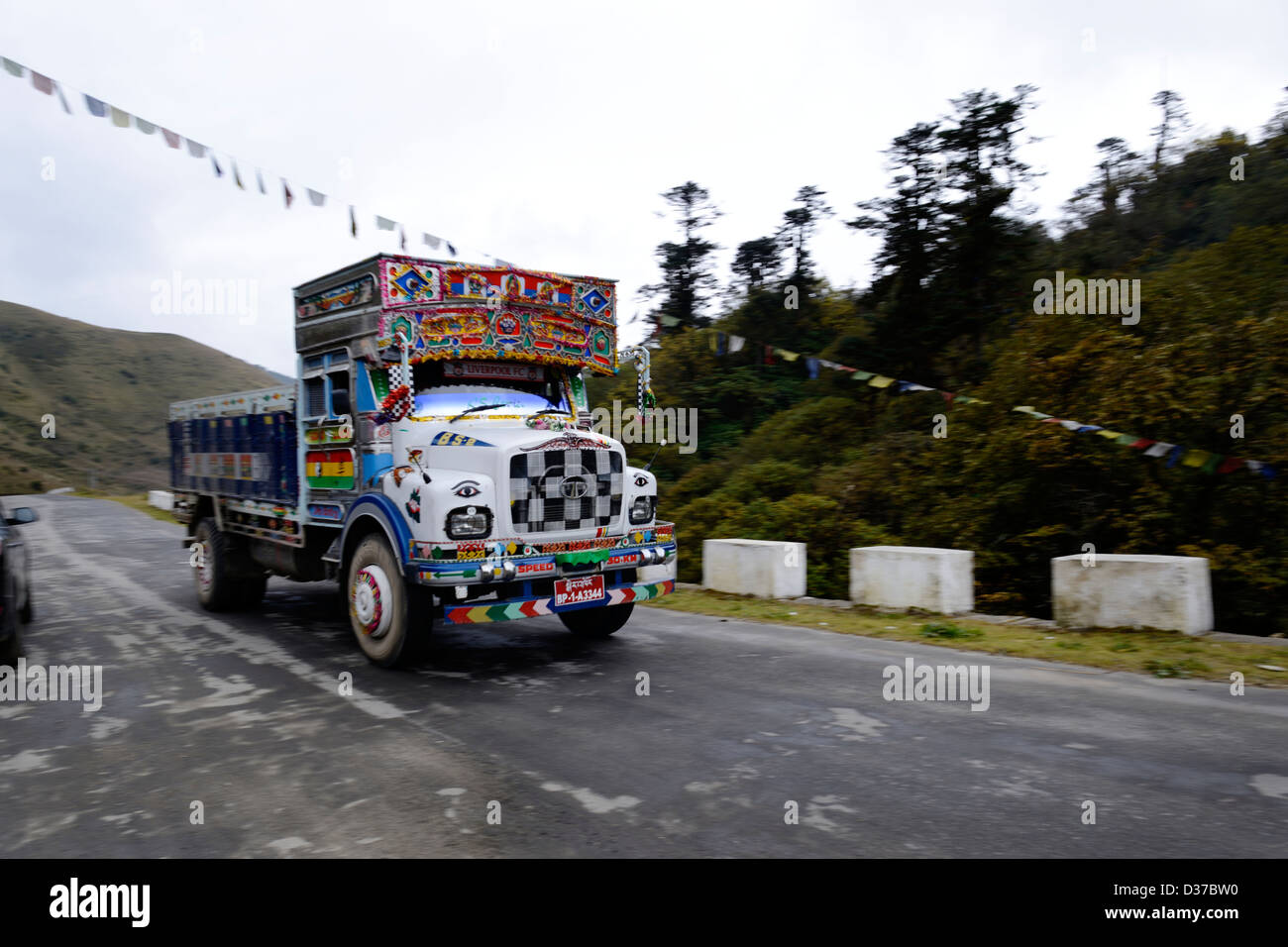 Decorative truck traveling mountain roads of Bhutan, decorated with Buddhist symbols,also Liverpool FC scarf,Pele La,pass,36MPX Stock Photo