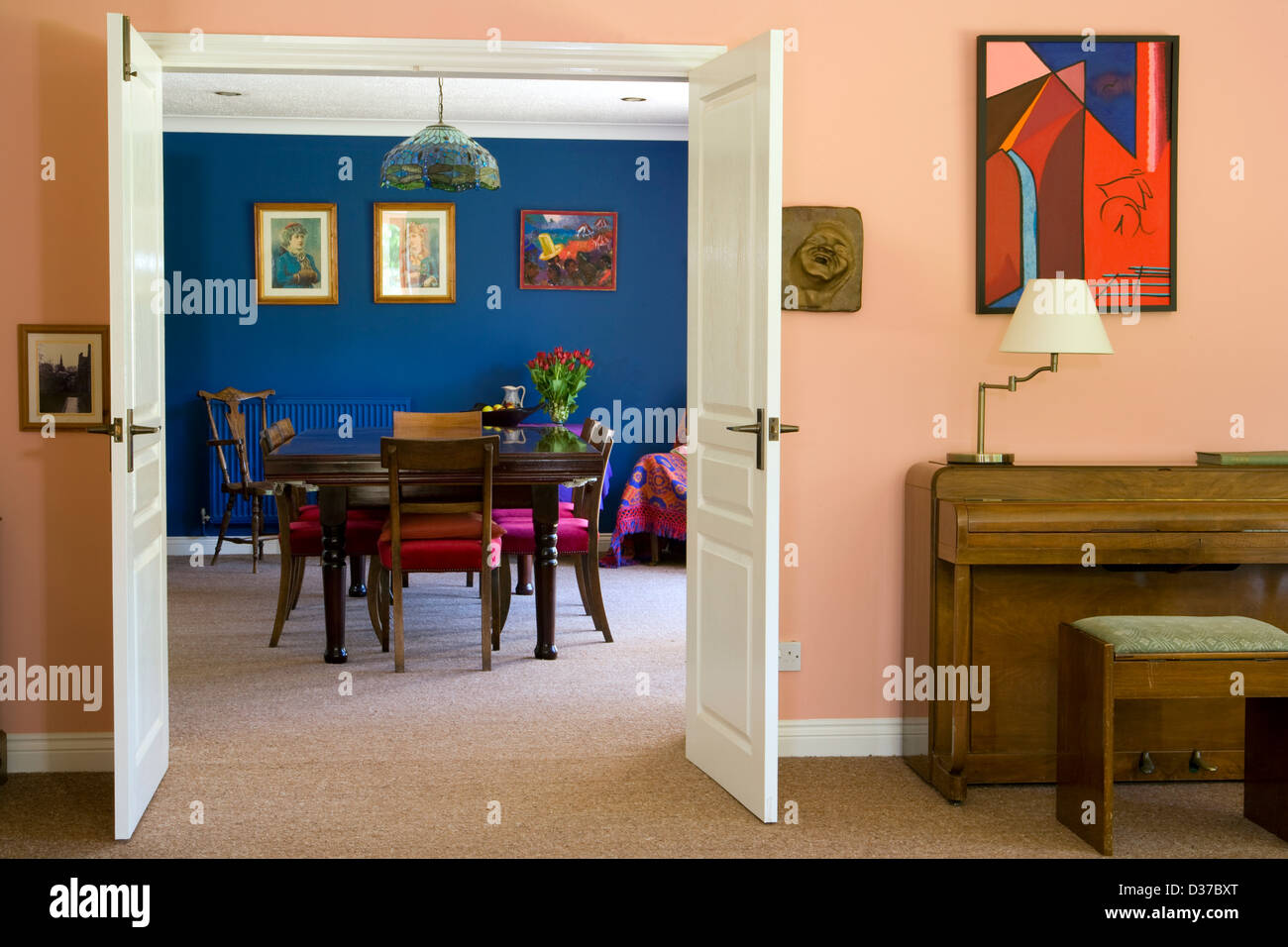 Contrasting colours in the decor of a ding room seen through double doors. Stock Photo