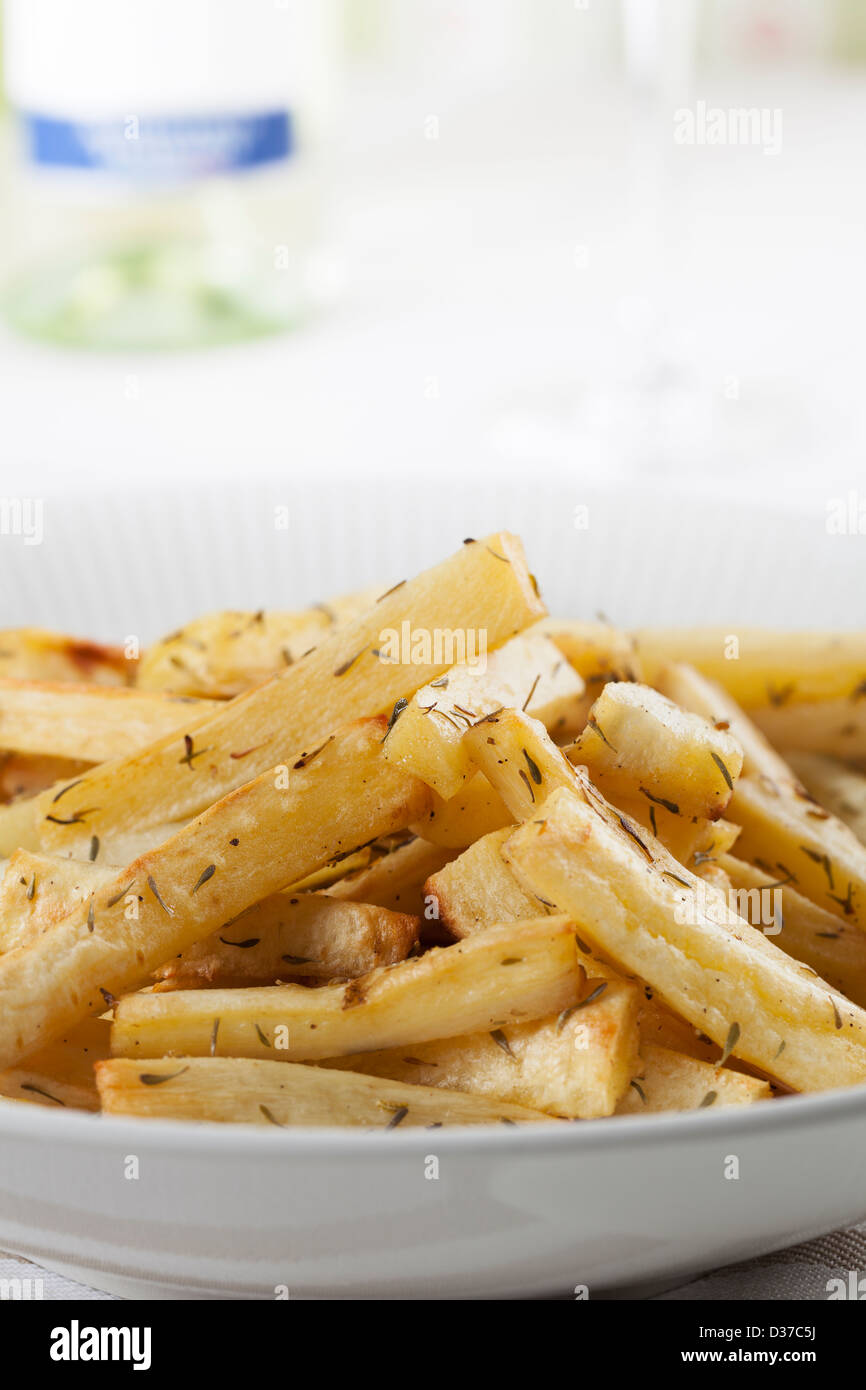 Cut roasted parsnips (or potatoes) with herbs. Stock Photo