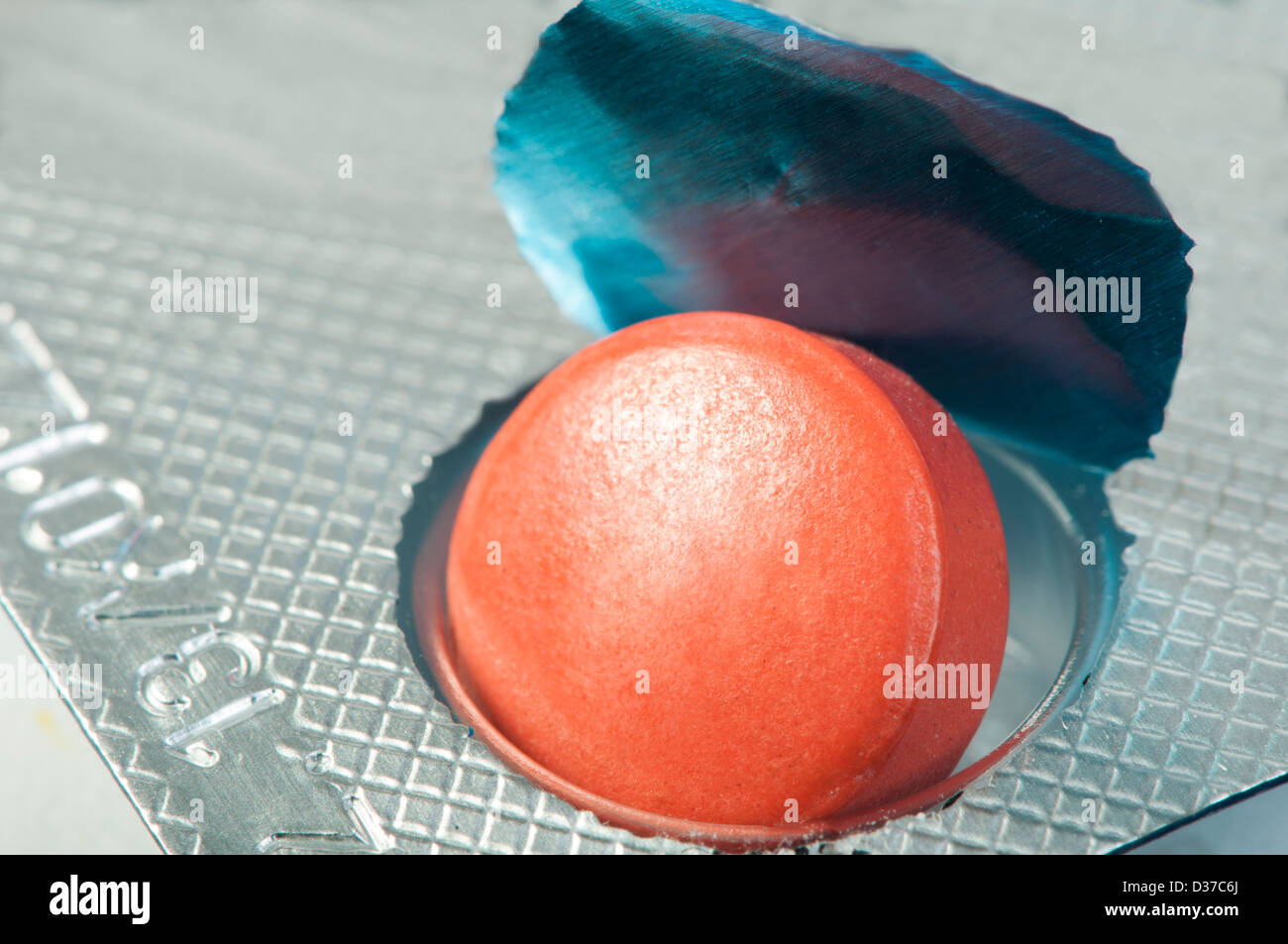 Red pill in a pack very close up. Macro studio shot Stock Photo