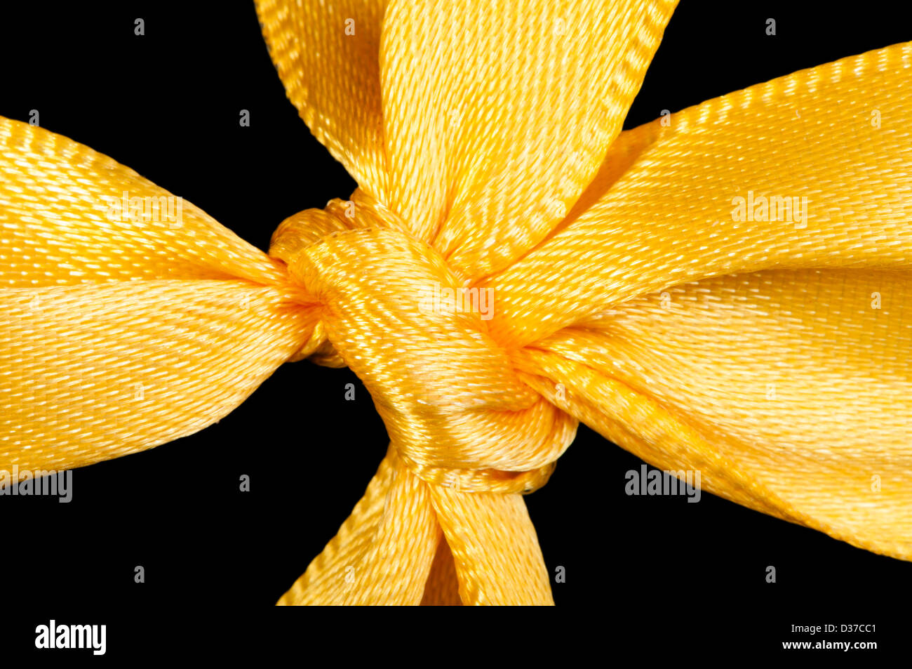 Yellow ribbon and knot isolated. Close up studio shot Stock Photo Alamy