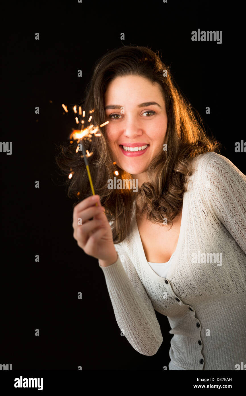 Woman holding sparkler Stock Photo Alamy