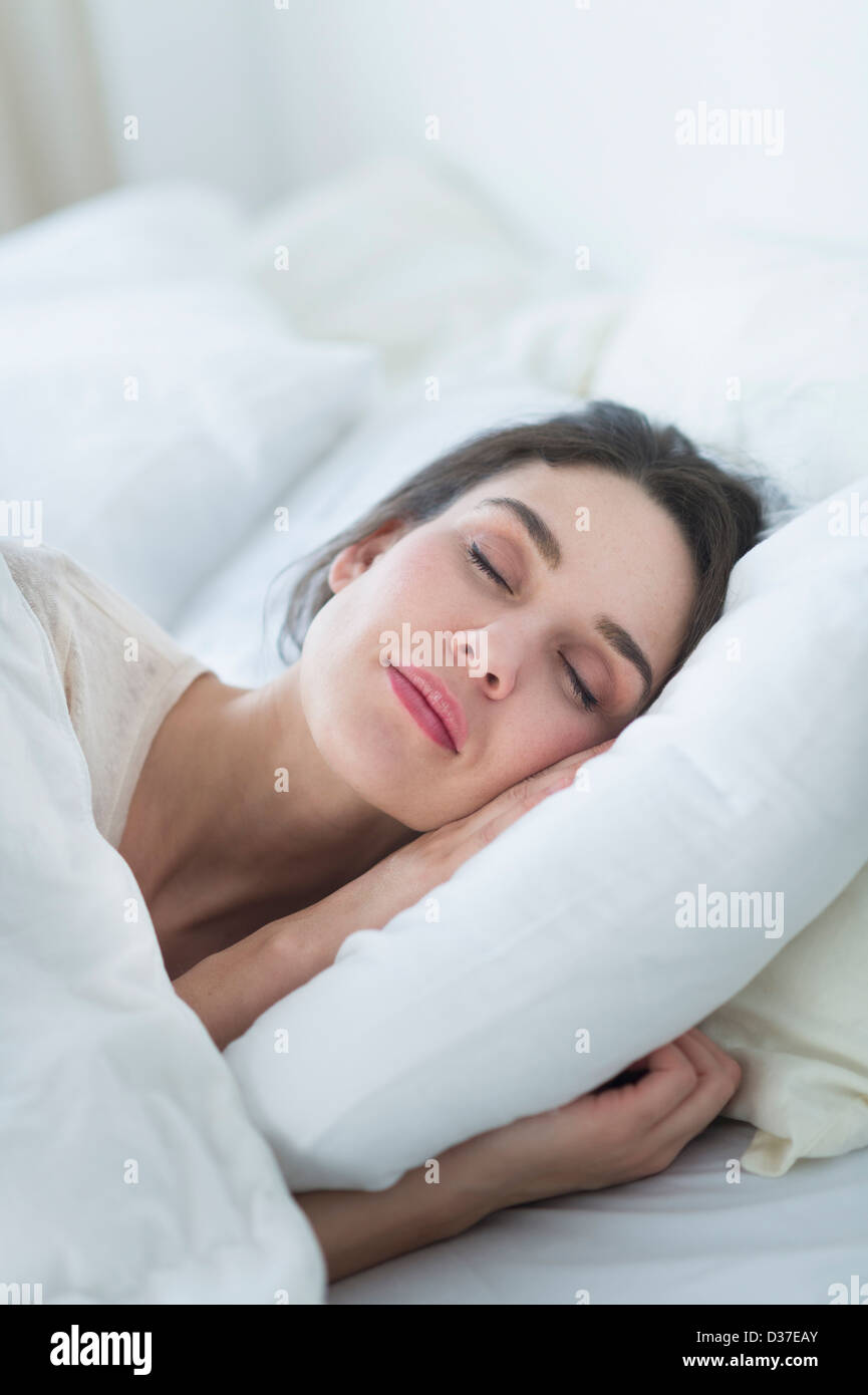 USA, New Jersey, Jersey City, Woman sleeping in bed Stock Photo