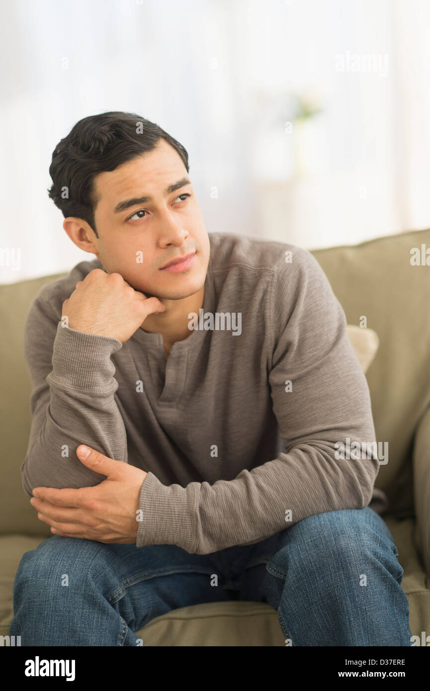 Young man sitting one hand hi-res stock photography and images - Alamy