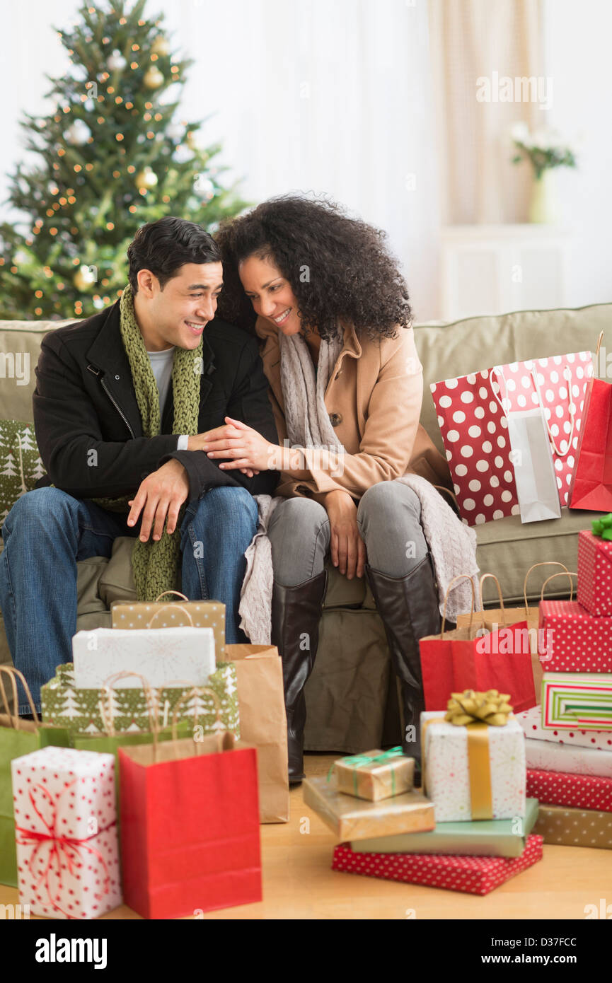 USA, New Jersey, Jersey City, Couple with Christmas presents in living room Stock Photo