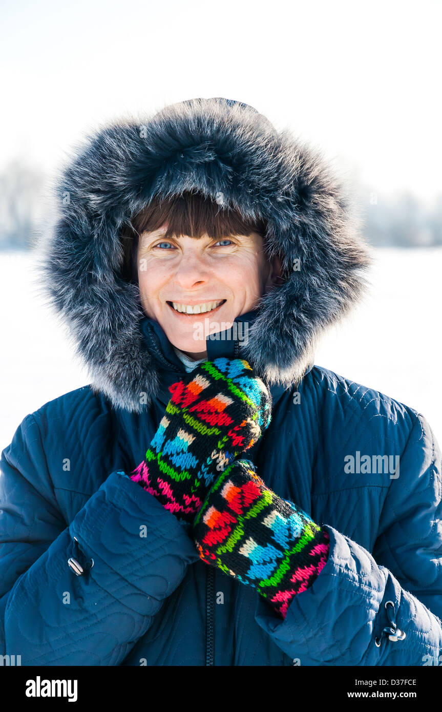 A soft portrait of a fifty years old woman. The image is shot on an iced lake, giving a nice light reflection from the ground Stock Photo