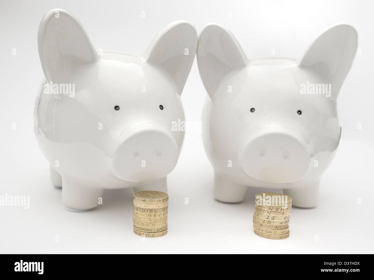 two piggy banks with english currency coins Stock Photo Alamy
