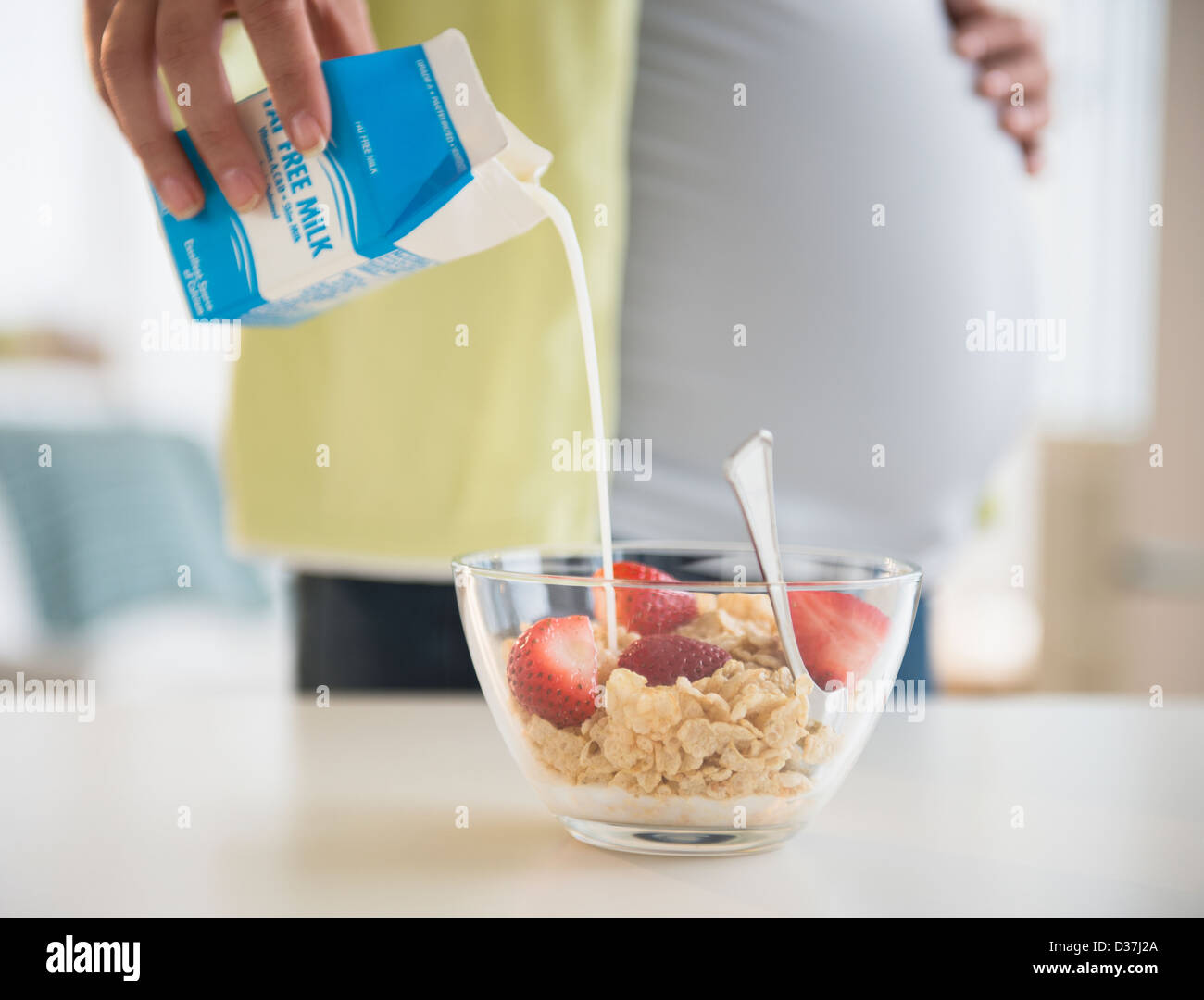 Pregnant woman preparing breakfast Stock Photo