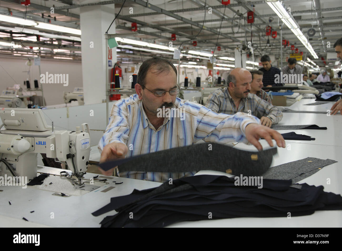 Istanbul, Turkey, people at sewing machines in a textile factory Stock