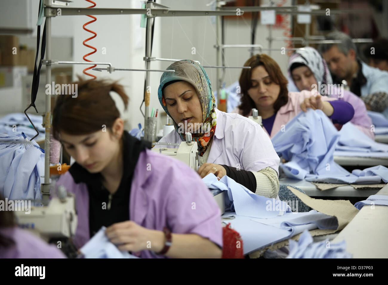 Istanbul, Turkey, people at sewing machines in a textile factory Stock