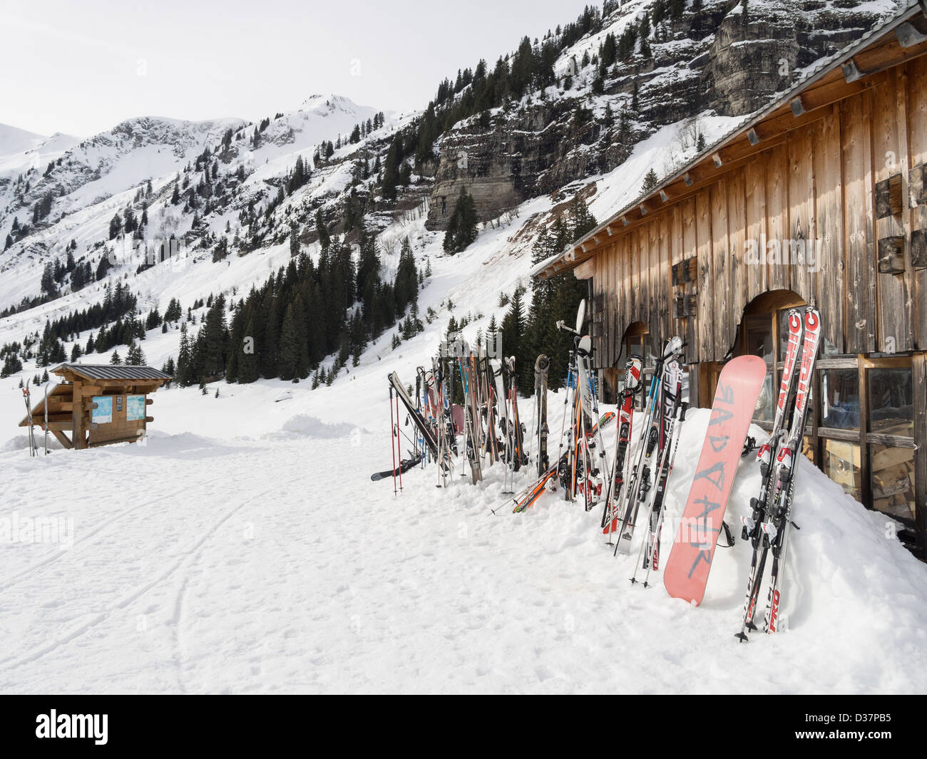 Skis standing in snow outside Gite du Lac de Gers lakeside ski restaurant in Le Grand Massif in French Alps. Sixt Samoens France Stock Photo
