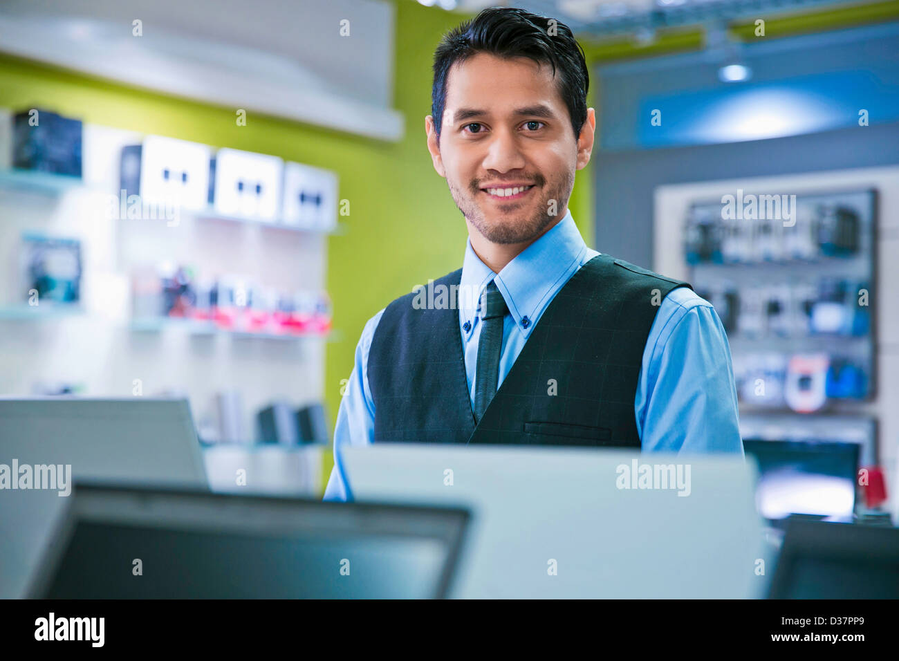 Salesman smiling in store Stock Photo