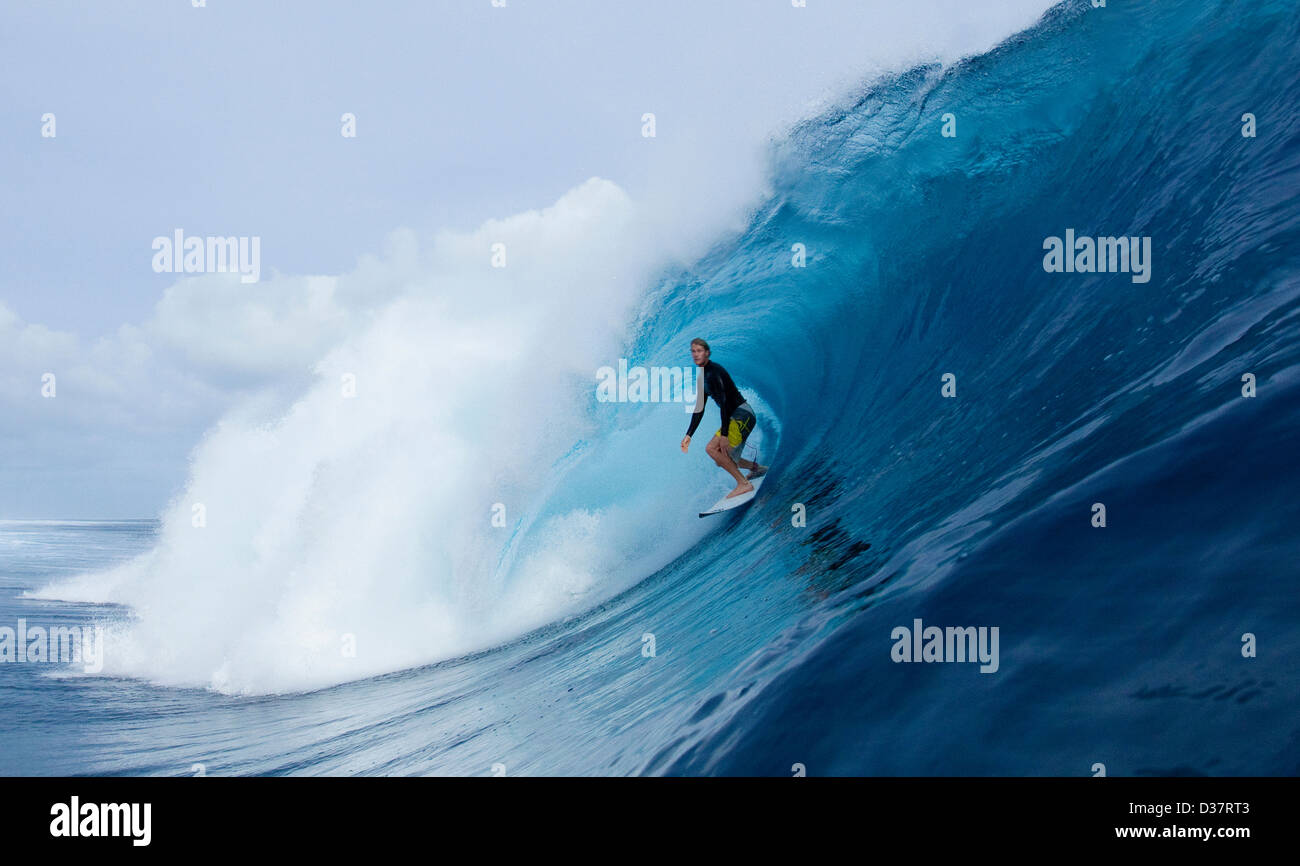 Man surfing in curl of wave Stock Photo