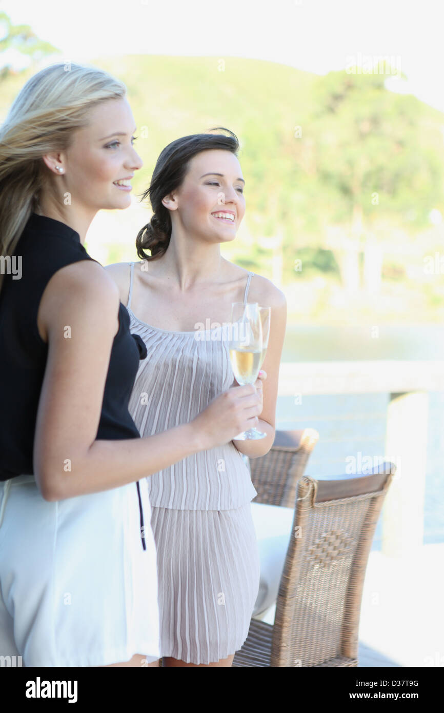 Women drinking wine together outdoors Stock Photo