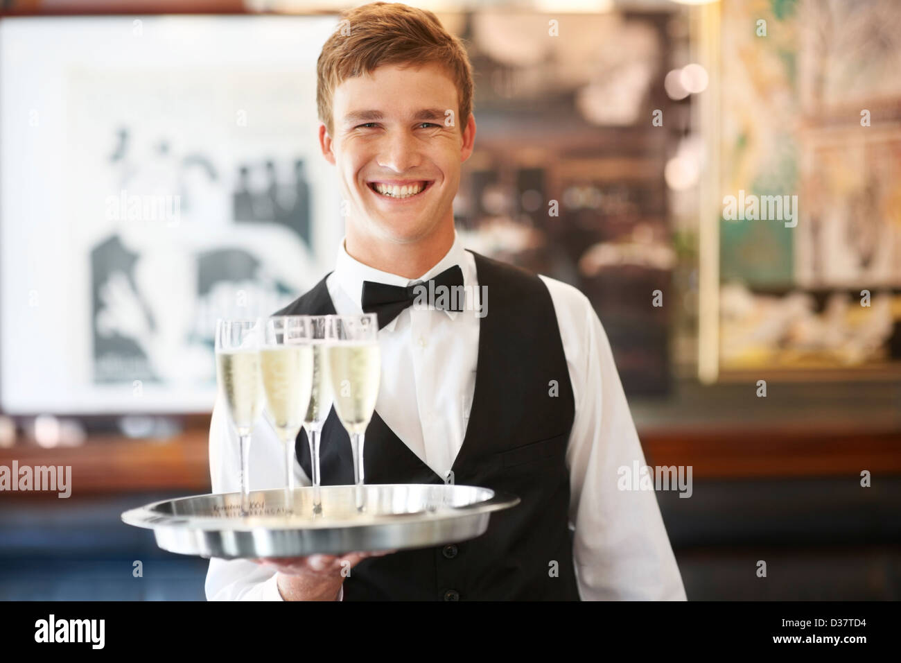 Waiter holding tray champagne hi-res stock photography and images - Alamy