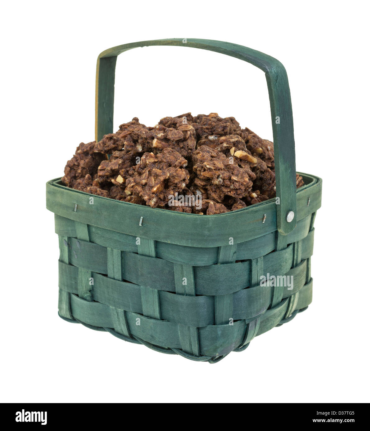 An old hand woven wood basket with handle filled with chocolate almond granola pieces. Stock Photo