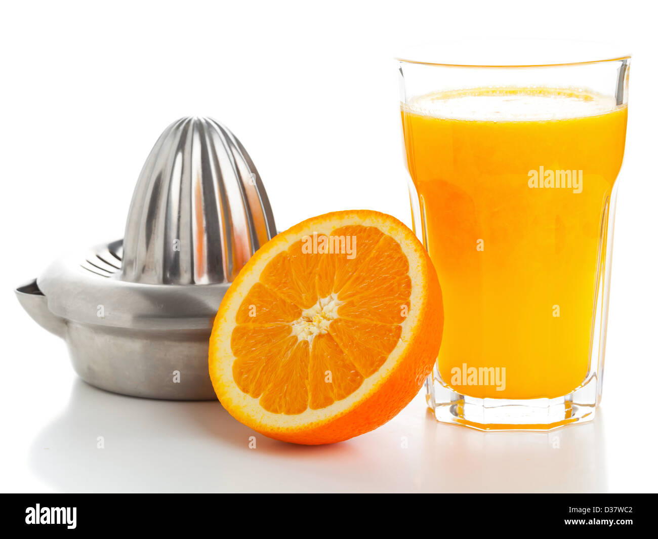 Glass of freshly pressed orange juice with sliced orange half and juice
