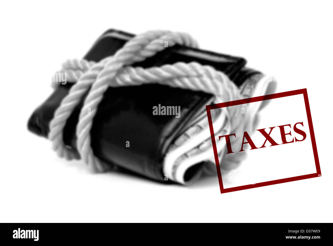 Bulging wallet tied with rope and a taxes due stamp Stock Photo
