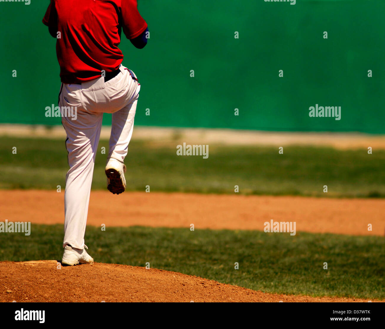 Baseball player wearing uniform throwing baseball Stock Photo