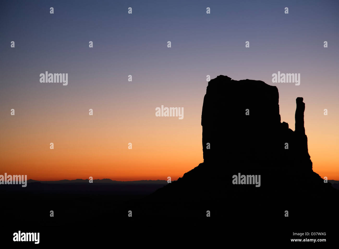 West Mitten silhouetted against morning sky, Monument Valley, Arizona Utah border USA Stock Photo