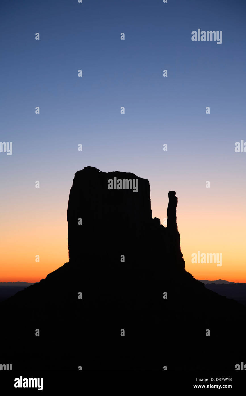 West Mitten silhouetted against morning sky, Monument Valley, Arizona Utah border USA Stock Photo